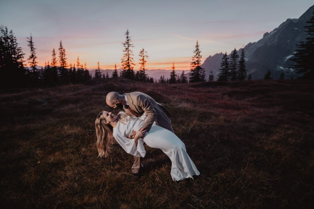 Groom lifting and carrying the bride in his arms.