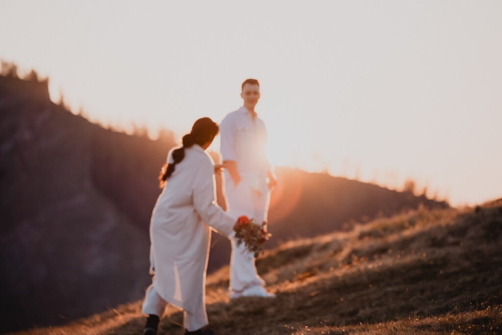 Couple walking uphill together in warm evening sunlight.