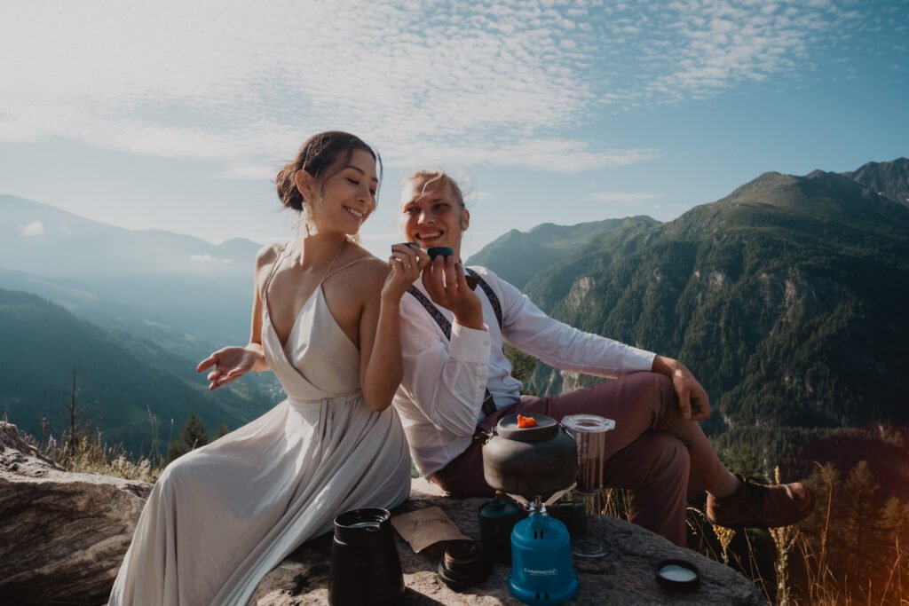 Couple laughing during a mountain picnic.