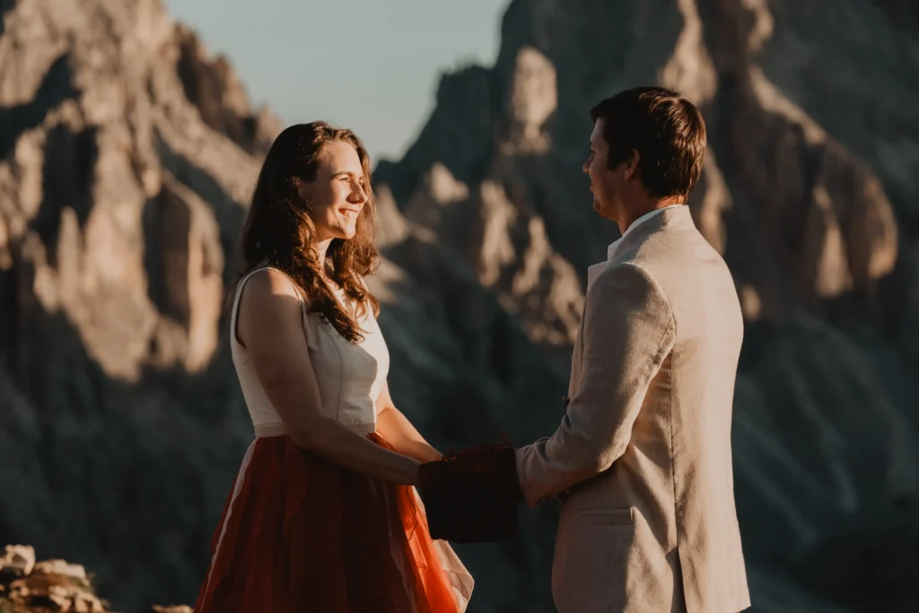Couple holding hands and smiling during their ceremony.