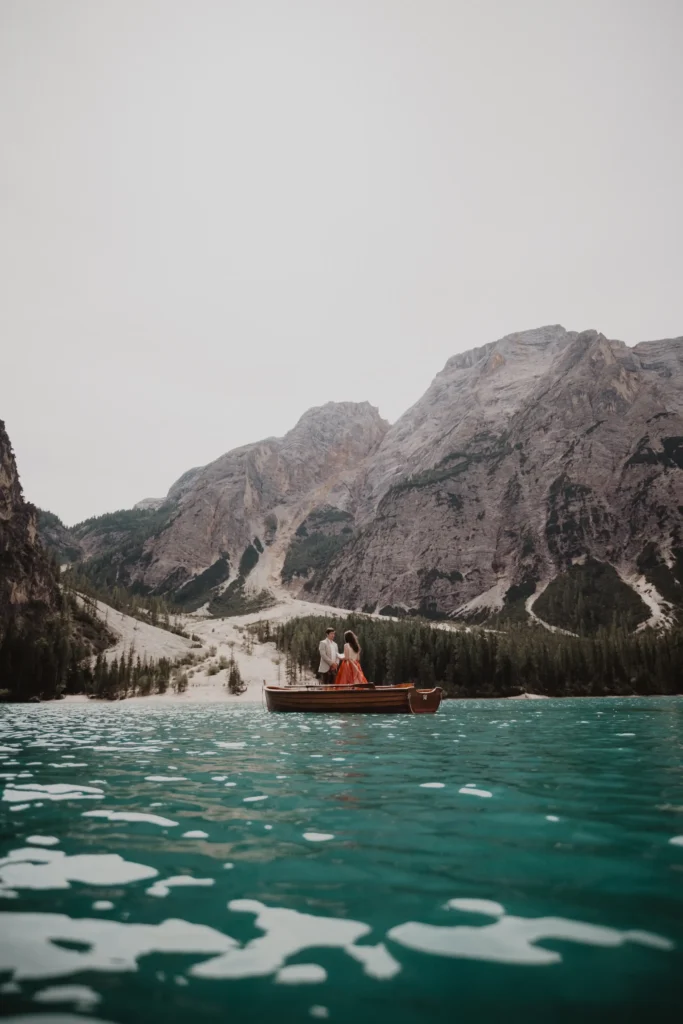 Couple in a rowing boat on a mountain lake.
