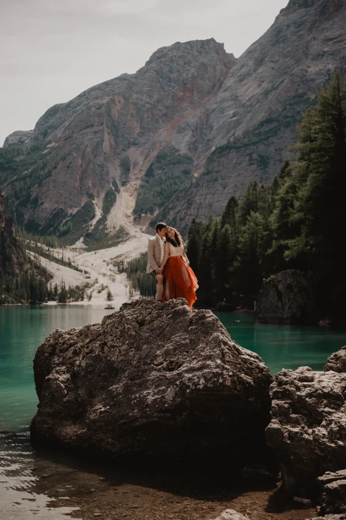 Couple on a rock above the lake.
