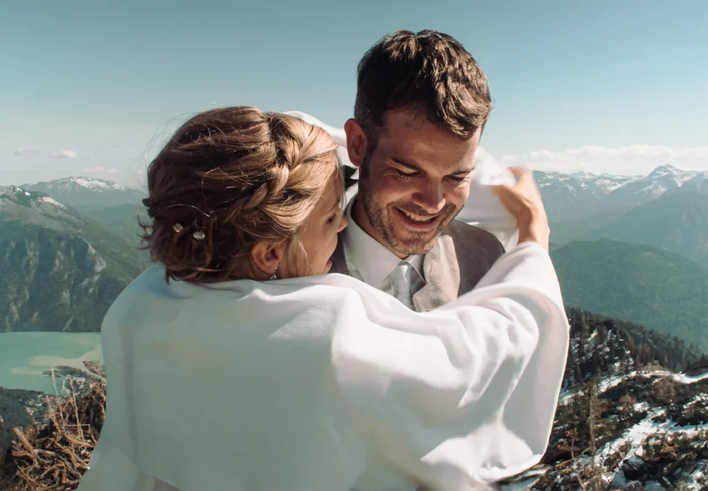 Bride embracing the laughing groom.