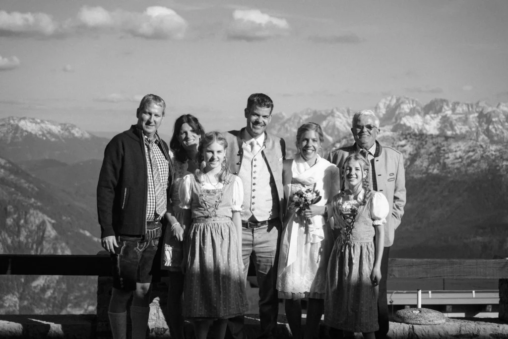 Black-and-white photograph of a small wedding group in the mountains.