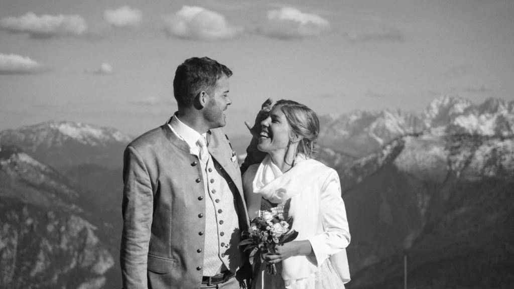 Black-and-white portrait of a couple looking at each other.