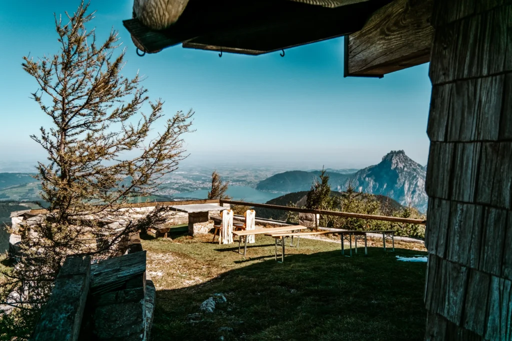 Empty terrace beside a wooden mountain hut overlooking the peaks.