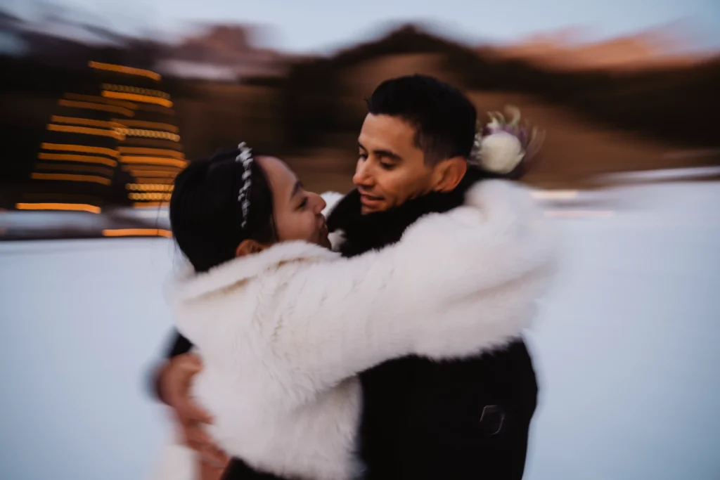 Couple embracing in a motion-blurred winter portrait.